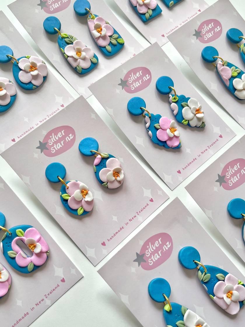 Cards feature Blue Floral Polymer Clay Earrings by silverstar.nz with playful pink, blue, and white flower designs. Crafted for casual wear, these handmade earrings include stainless steel hooks.