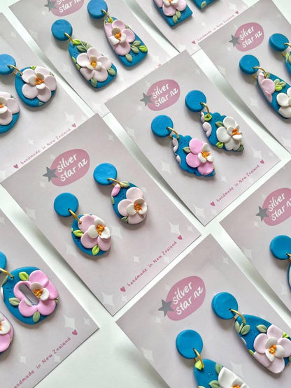 Cards feature Blue Floral Polymer Clay Earrings by silverstar.nz with playful pink, blue, and white flower designs. Crafted for casual wear, these handmade earrings include stainless steel hooks.