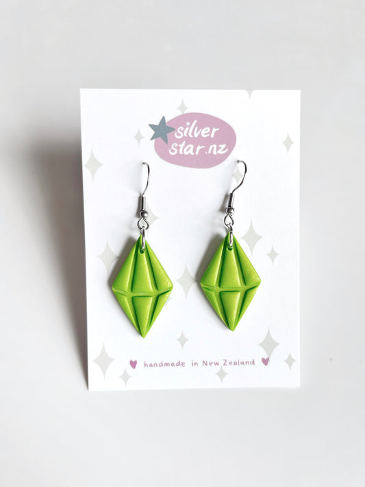 Green Diamond Polymer Clay Earrings by silverstar.nz are shown on a white branded card reading "handmade in New Zealand." The handmade earrings feature stainless steel hooks, displayed against a plain light background.