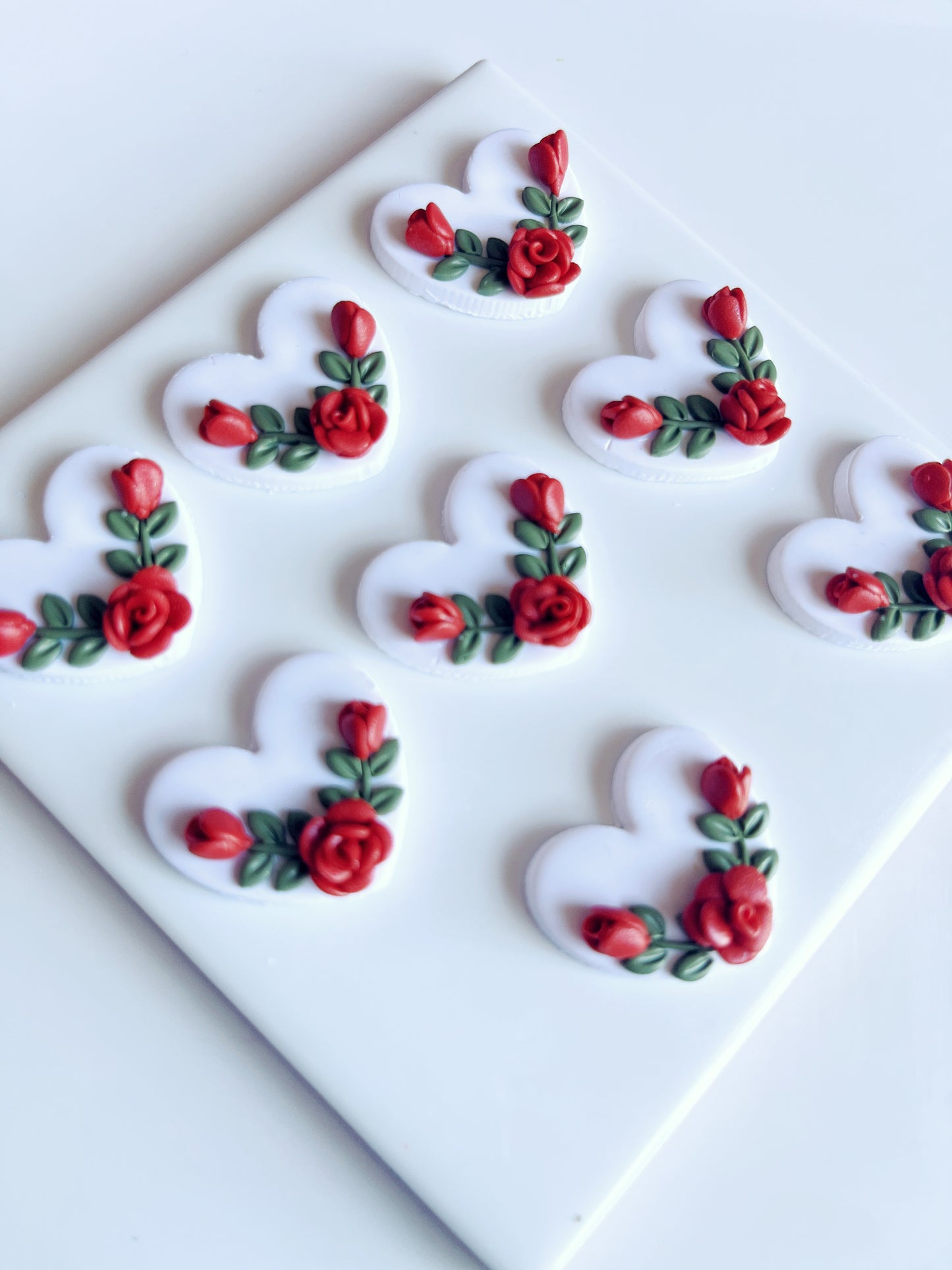The Heart Rose Floral Polymer Clay Earrings by silverstar.nz feature a funky design with heart shapes, red roses, and green leaves, adding flair to any style.