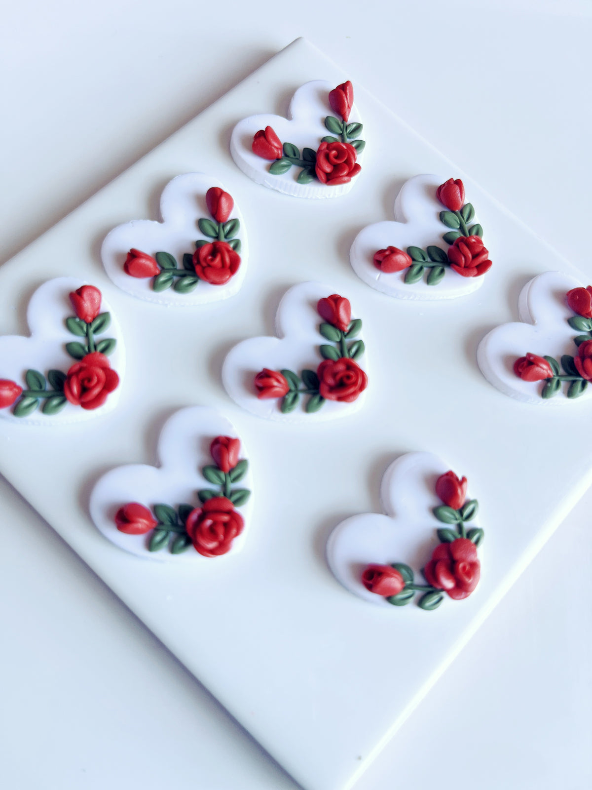 The Heart Rose Floral Polymer Clay Earrings by silverstar.nz feature a funky design with heart shapes, red roses, and green leaves, adding flair to any style.